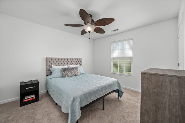 bedroom featuring light carpet, baseboards, visible vents, and a ceiling fan