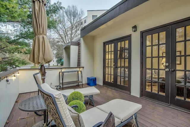 view of wooden balcony with a wooden deck and french doors