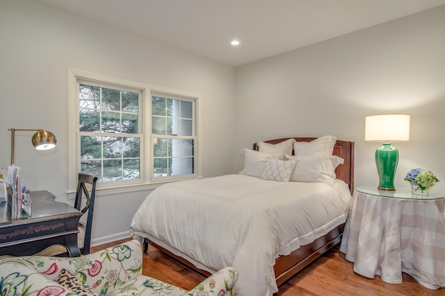 bedroom with wood finished floors and recessed lighting