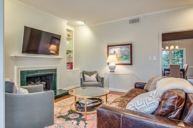 living room with a high end fireplace, visible vents, crown molding, and wood finished floors