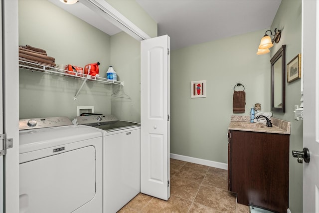 clothes washing area featuring washing machine and dryer, a sink, laundry area, baseboards, and tile patterned floors