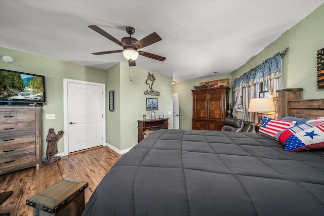 bedroom with baseboards, a ceiling fan, and wood finished floors