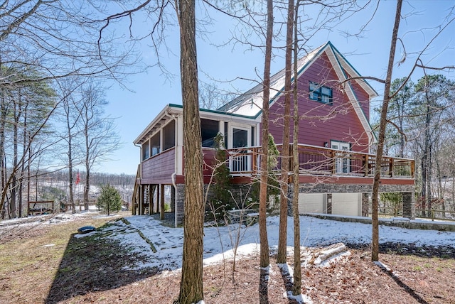 view of snow covered exterior featuring a garage