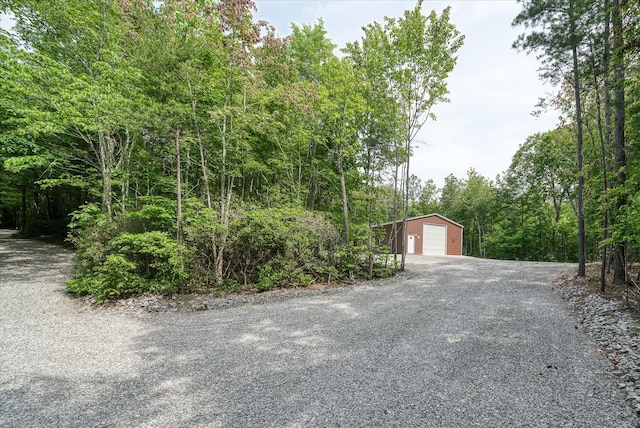 101 Dakota Ln, Spencer, TN 38585 - detached garage with gravel driveway and a forest view