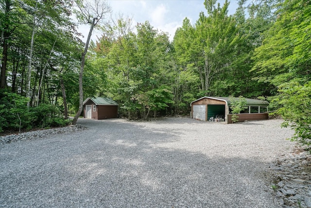 101 Dakota Ln, Spencer, TN 38585 - detached garage featuring a forest view and a storage shed