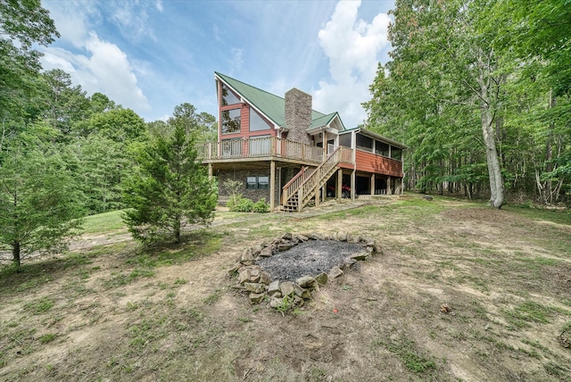 101 Dakota Ln, Spencer, TN 38585 - rear view of house featuring a wooden deck, stairway, a chimney, and a metal roof