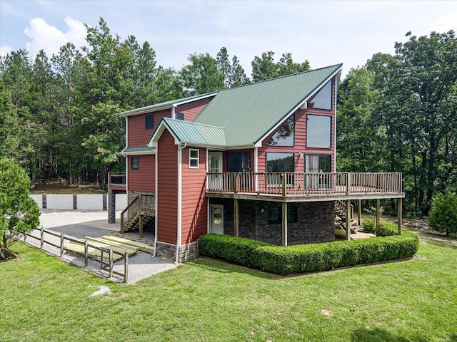 101 Dakota Ln, Spencer, TN 38585 - rear view of property featuring stairway, stone siding, a wooden deck, and a lawn