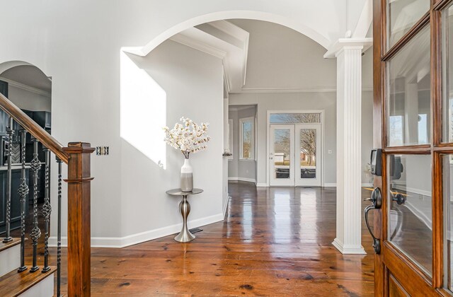 entryway with ornamental molding, hardwood / wood-style floors, stairs, and baseboards