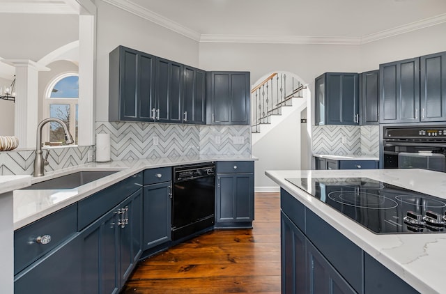 kitchen with dark wood-style floors, light stone countertops, crown molding, black appliances, and a sink