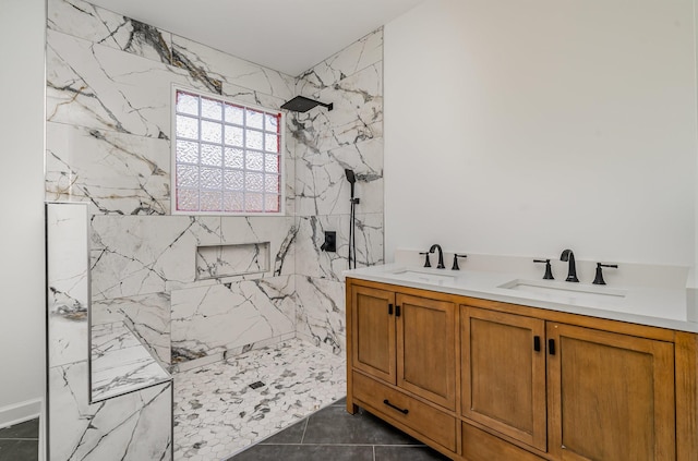 full bath with tile patterned flooring, a sink, a marble finish shower, and double vanity