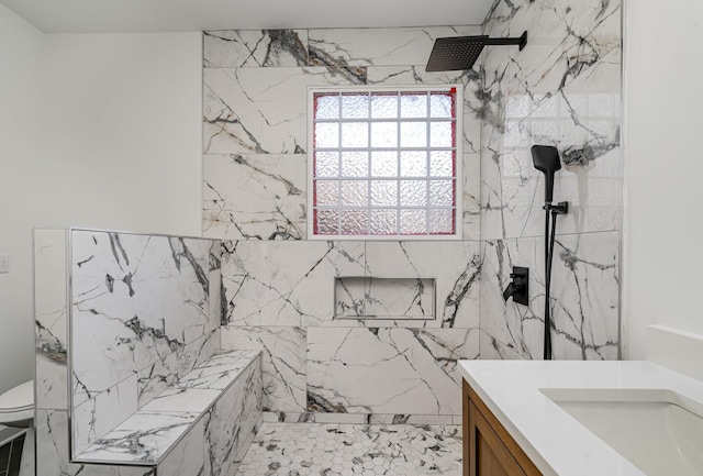 bathroom with toilet, vanity, and a marble finish shower