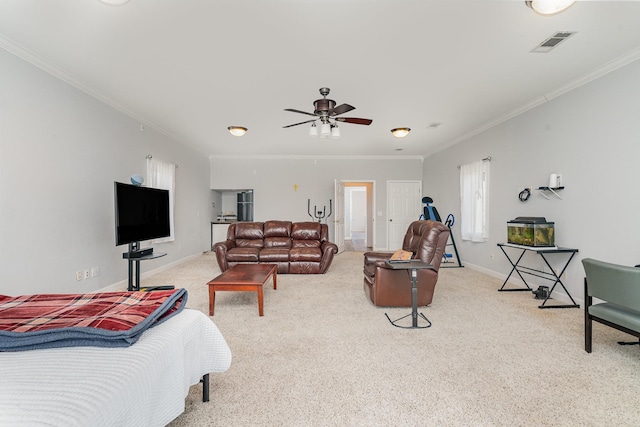 living area with carpet floors, visible vents, crown molding, and baseboards