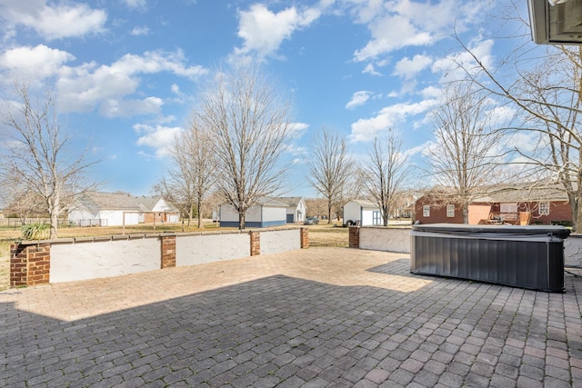 view of patio featuring a residential view and a hot tub