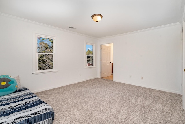 carpeted bedroom featuring baseboards, visible vents, and crown molding