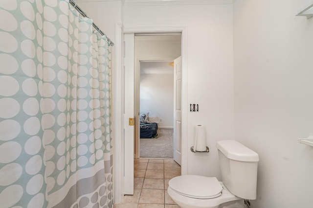 bathroom with a shower with shower curtain, tile patterned flooring, and toilet