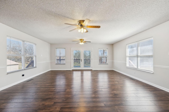 unfurnished living room featuring a ceiling fan, dark wood-style flooring, visible vents, and baseboards