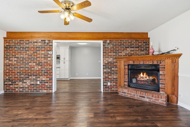 unfurnished living room featuring dark wood-style floors, a brick fireplace, a textured ceiling, and baseboards