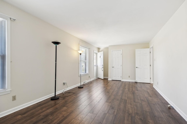 interior space featuring dark wood-style floors and baseboards