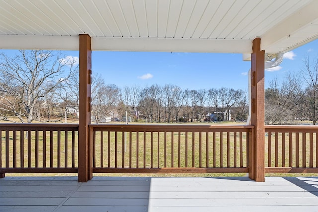 wooden terrace with a lawn