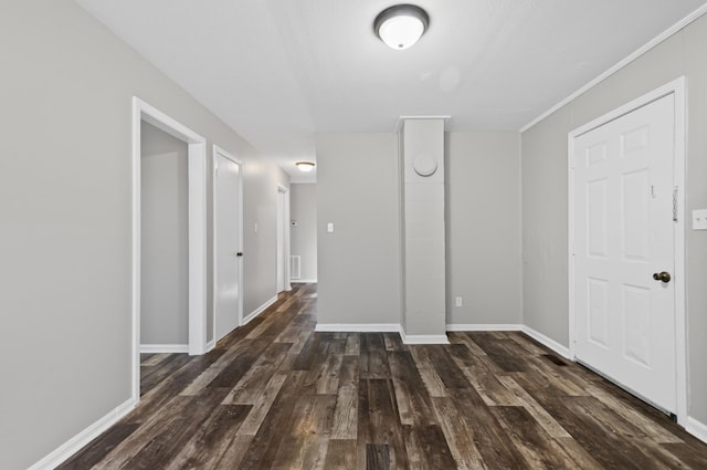 interior space with dark wood-style floors, visible vents, and baseboards