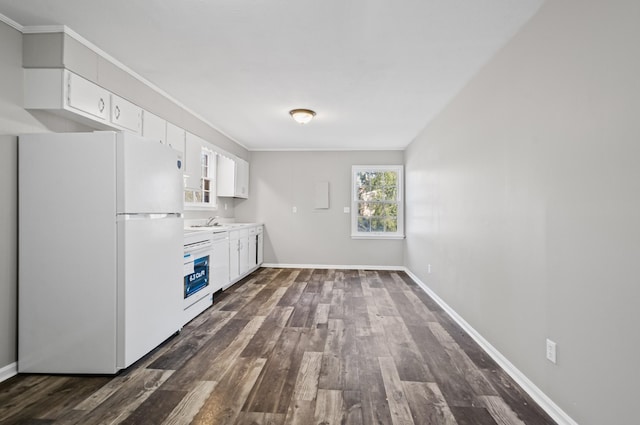 kitchen with dark wood-style floors, freestanding refrigerator, light countertops, and white cabinetry