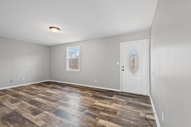 entryway featuring baseboards and dark wood-type flooring