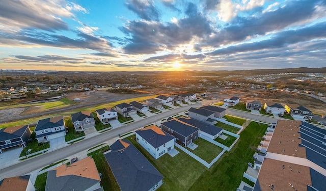 aerial view at dusk featuring a residential view