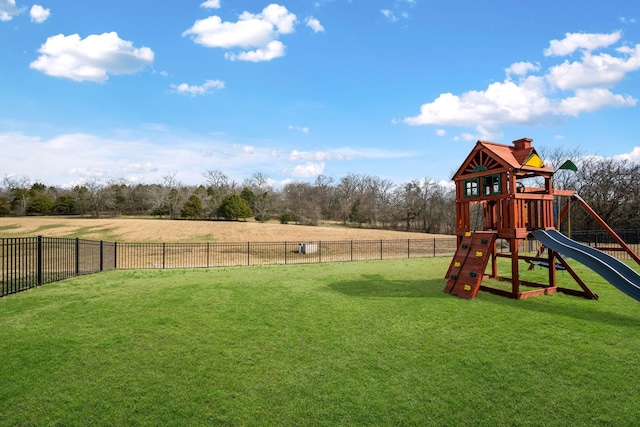 view of jungle gym with a yard and fence