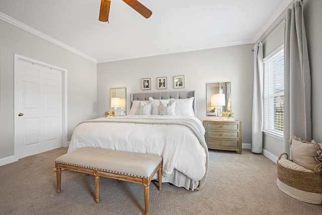 bedroom featuring a ceiling fan, carpet, baseboards, and crown molding