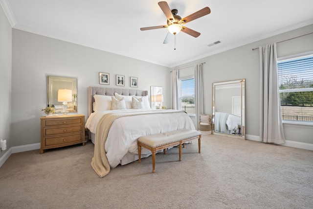 bedroom featuring ornamental molding, light carpet, baseboards, and a ceiling fan