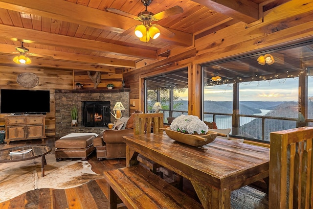 interior space featuring wooden ceiling, wood finished floors, a mountain view, and wooden walls