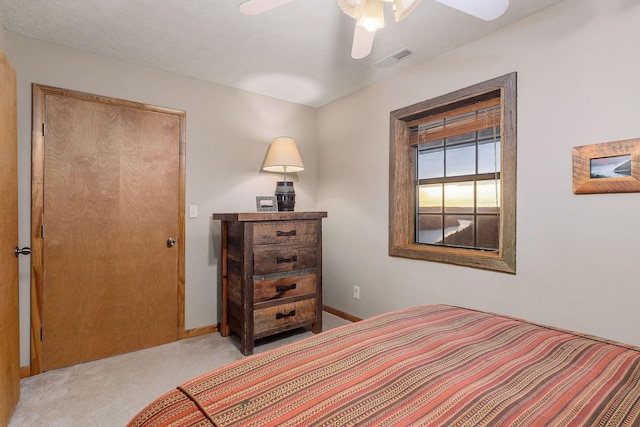 bedroom with visible vents, ceiling fan, light carpet, and baseboards