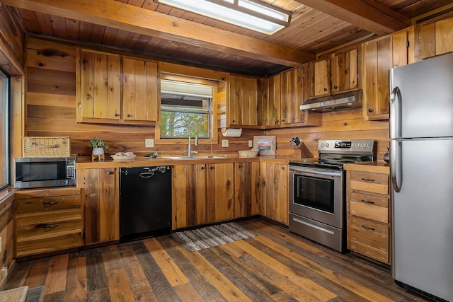 kitchen with beam ceiling, stainless steel appliances, light countertops, a sink, and under cabinet range hood