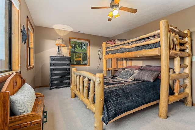 bedroom featuring ceiling fan, visible vents, and light colored carpet