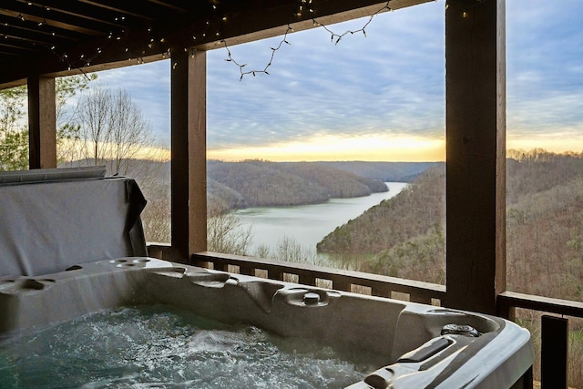 property view of water with a forest view