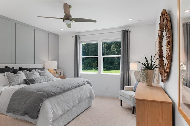 bedroom featuring a ceiling fan, recessed lighting, light colored carpet, and baseboards