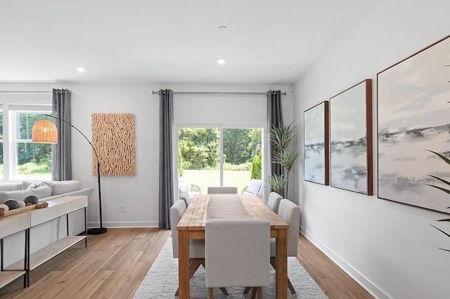 dining area featuring light wood-style flooring, baseboards, and recessed lighting