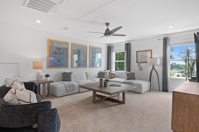 living area featuring attic access, visible vents, a ceiling fan, light colored carpet, and recessed lighting