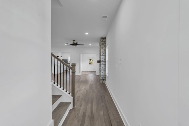 corridor with recessed lighting, wood finished floors, visible vents, baseboards, and stairs