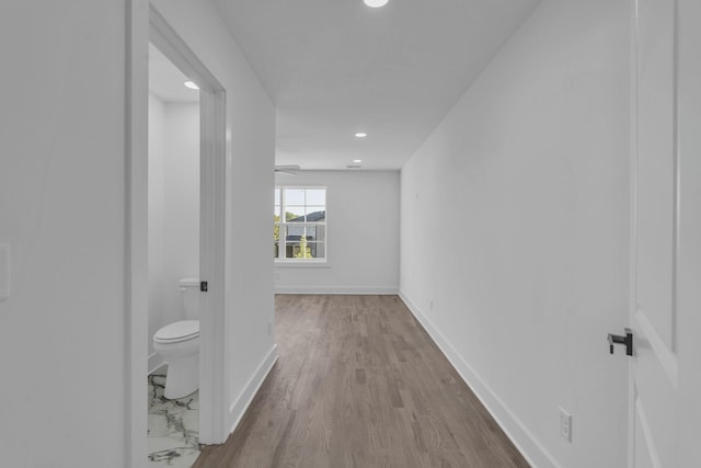 corridor with recessed lighting, light wood-style flooring, and baseboards