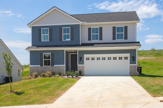 craftsman-style house featuring concrete driveway, board and batten siding, an attached garage, and a front yard