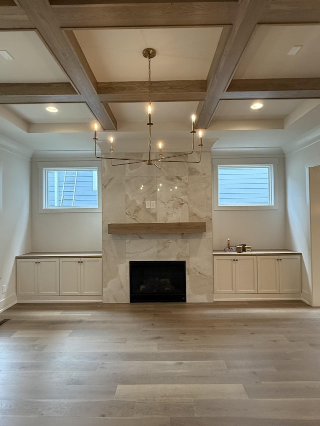 8007 Southvale Blvd, Franklin, TN 37064 - unfurnished living room with coffered ceiling, light wood-style floors, a chandelier, beamed ceiling, and a premium fireplace