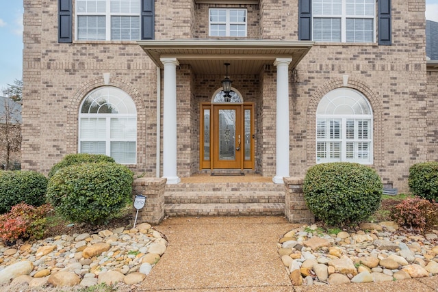 property entrance featuring brick siding