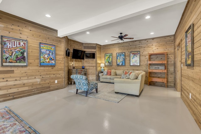 living room with a ceiling fan, recessed lighting, concrete floors, and beamed ceiling