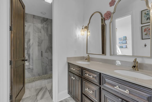 bathroom featuring marble finish floor, a sink, a marble finish shower, and double vanity