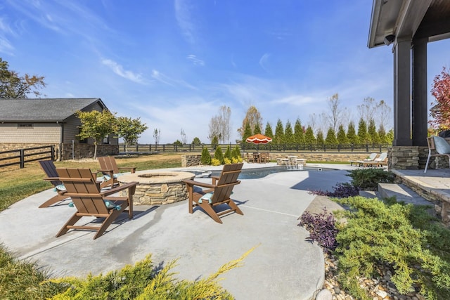 view of patio featuring a fenced backyard and a fire pit