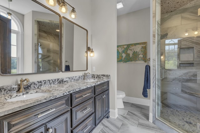 bathroom with a sink, baseboards, marble finish floor, a shower stall, and double vanity