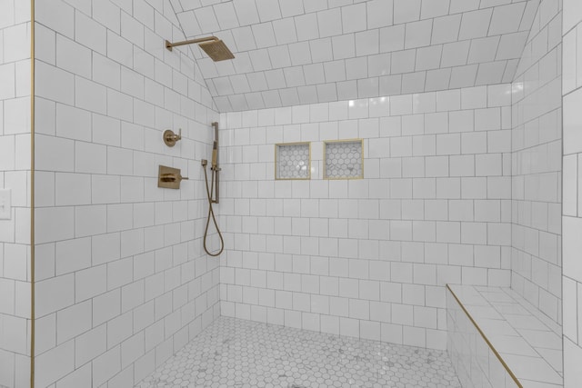 full bathroom featuring tiled shower