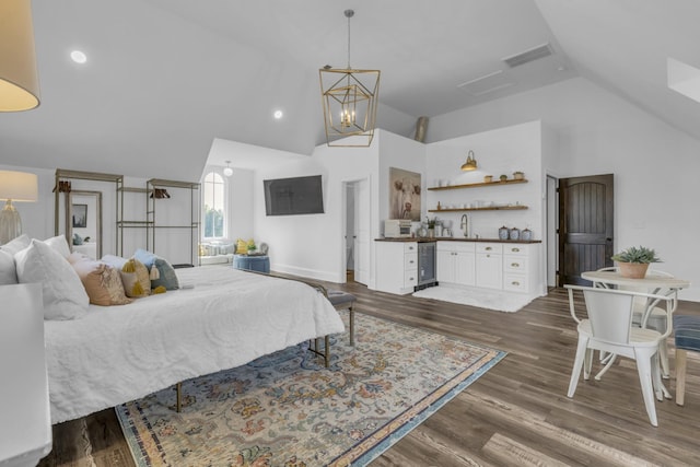 bedroom featuring wine cooler, bar, a sink, visible vents, and dark wood finished floors