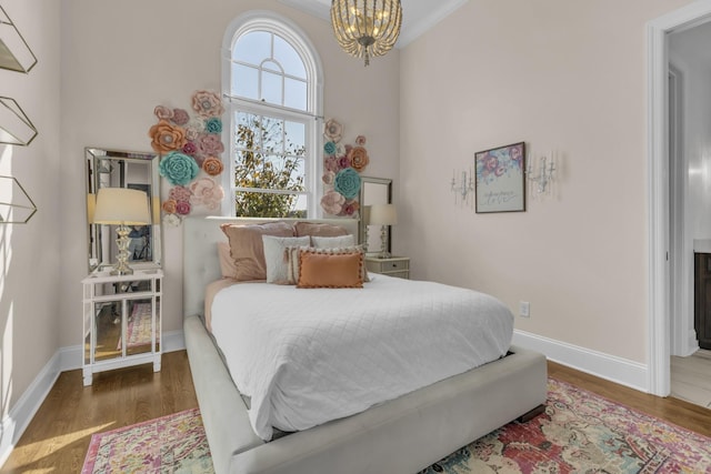 bedroom featuring dark wood-style floors, baseboards, and a notable chandelier